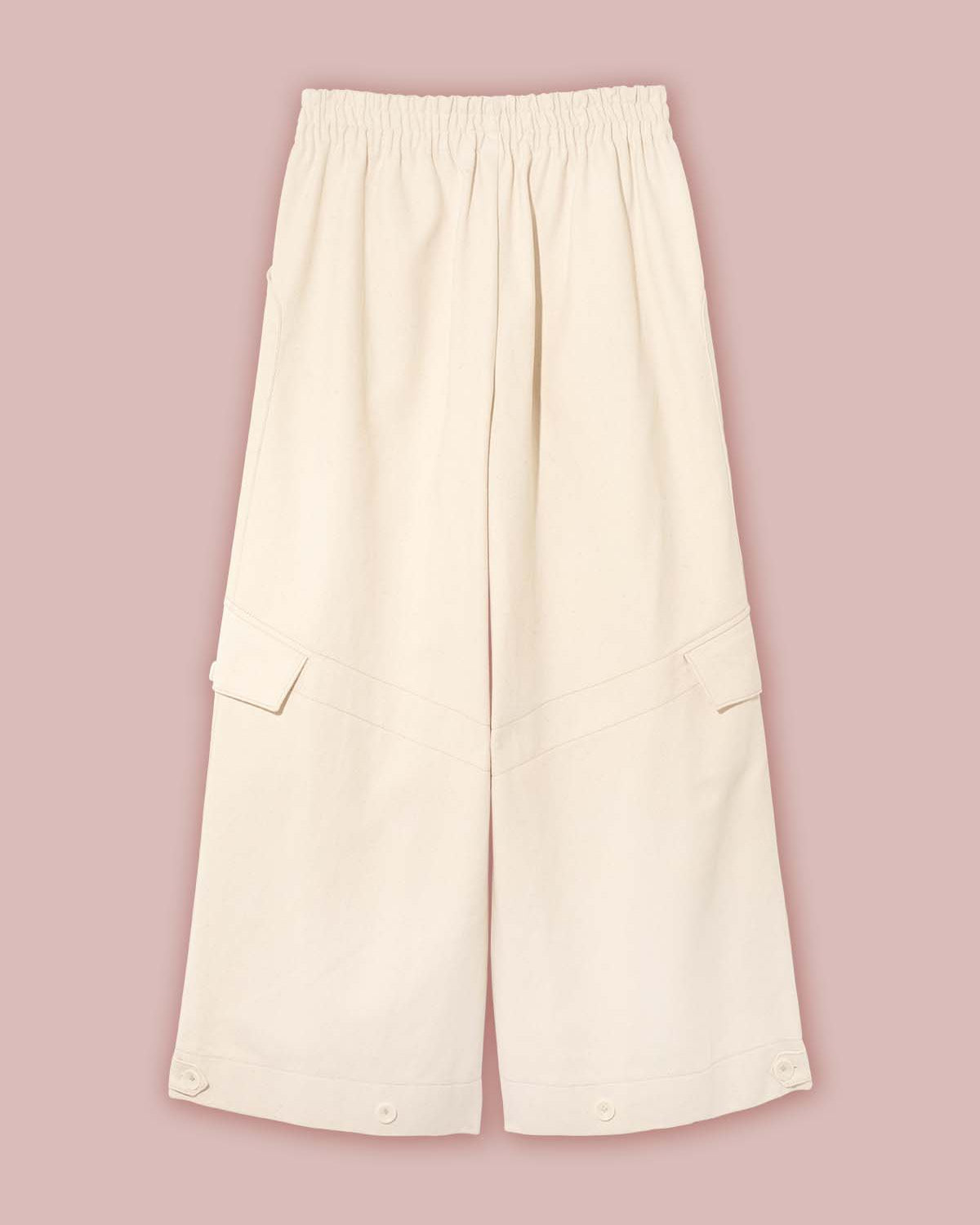 Flat view of the front of the Asmuss Eddy Cargo Trousers in Ecru showing the side pockets, leg pockets, and hem button tabs