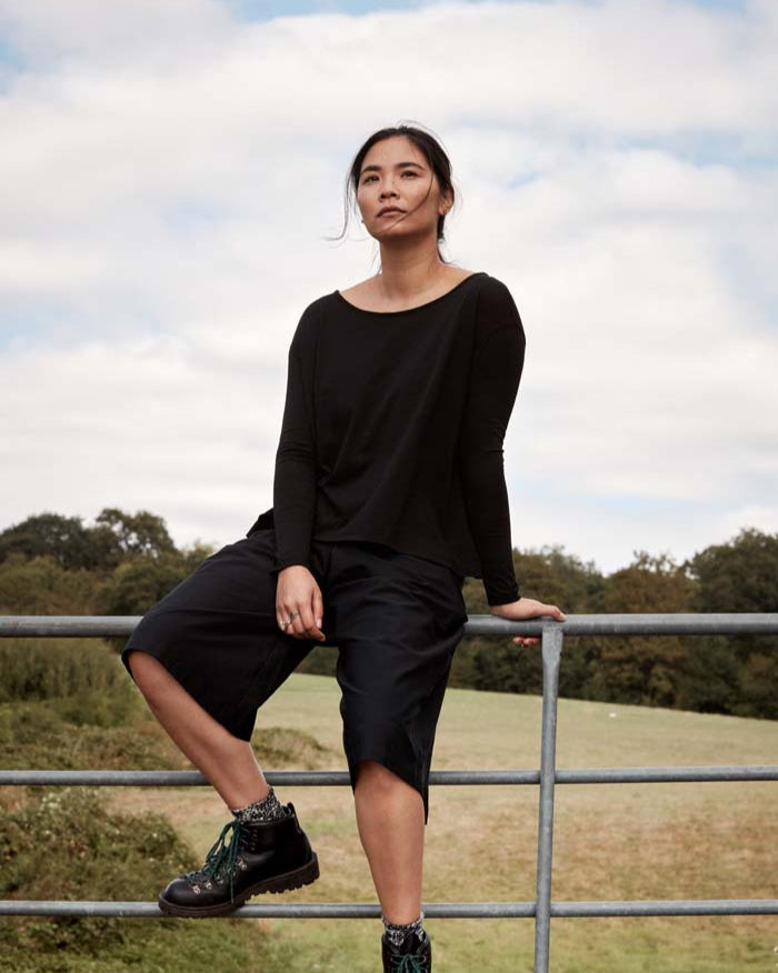 Woman wearing Asmuss A-line Long Sleeve T-shirt in Black. A perfect elevated essential with built in temperature regulating technology