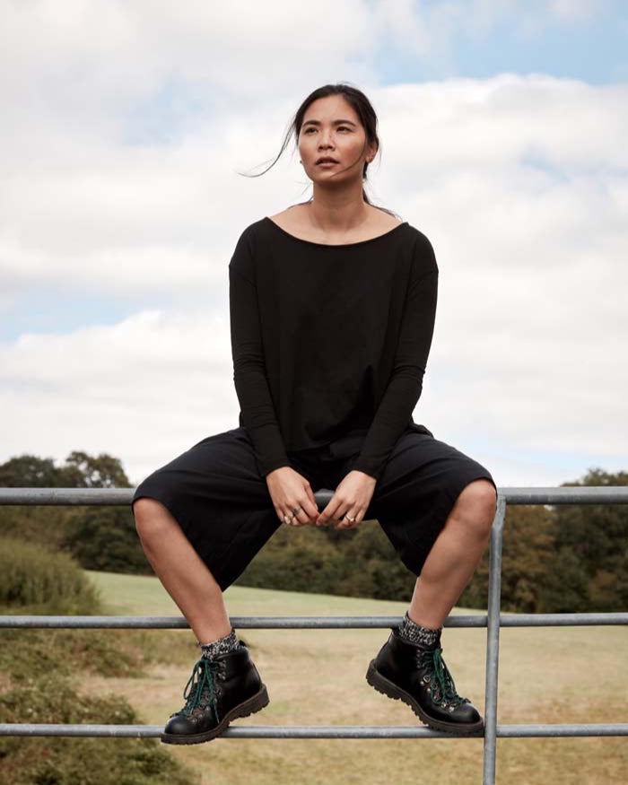 Woman wearing the elevated essential Asmuss A-line Long Sleeve T-shirt in Black. The perfect everyday and travel top as it adapts to your own microclimate through clever built in technology