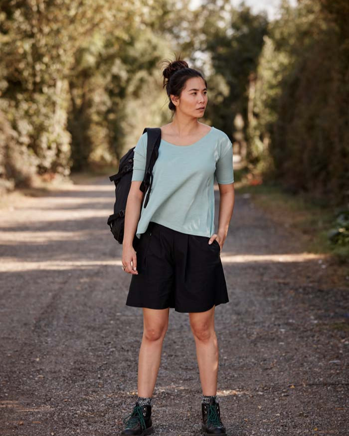 Modern women out for a hike in the Asmuss A-line T-shirt in Sea Green. An elevated essential t-shirt that drape beautifully in wool blended with temperature regulating 37.5 Technology. Perfect for your everyday adventures.