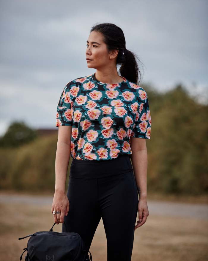 Woman wear the high waisted Asmuss Twisted Leggings with zip detail on lower front leg, pocket in front waistband and drawstring to keep them snug. Made in the UK from recycled nylon and elastane for 4 way stretch. Sustainable activewear that looks great on for all your everyday adventures including lazing on the couch or out running.