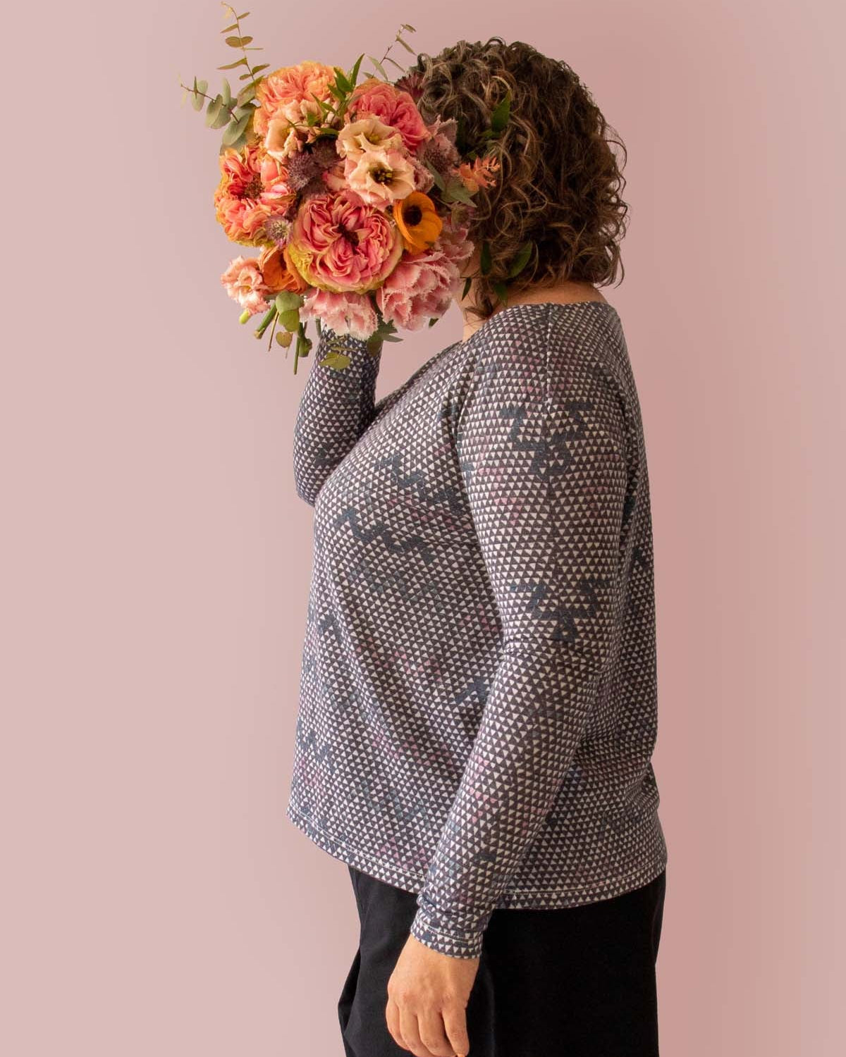 Asmuss Zig Zag A-line Long Sleeve T-shirt side view on model holding a bunch of beautiful flowers in front of her face