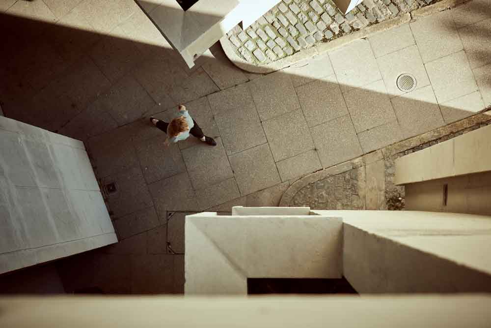 Looking down through Keeling House at a women walking below. Keeling House was mentioned in a list of the best Brutalist buildings