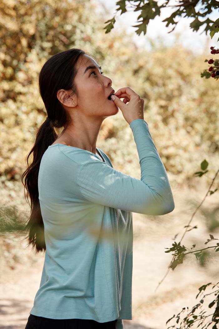 Women eating wild blackberries wearing Asmuss Aline Long Sleeve T-shirt in Sea Green. A great elevated essential top for the modern woman's everyday adventures