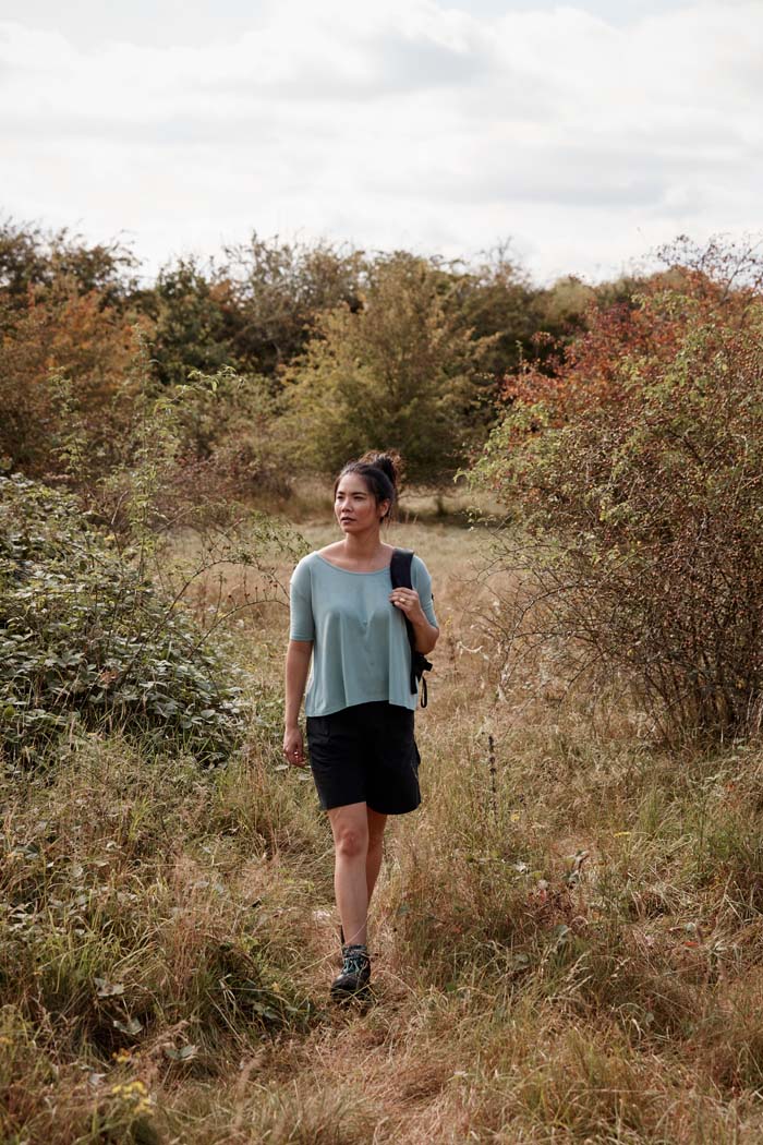 Modern women out for a walk in the countryside wearing the Asmuss A-line T-shirt in Sea Green. An elevated essential t-shirt that drape beautifully in wool blended with temperature regulating 37.5 Technology. Perfect for your everyday adventures.